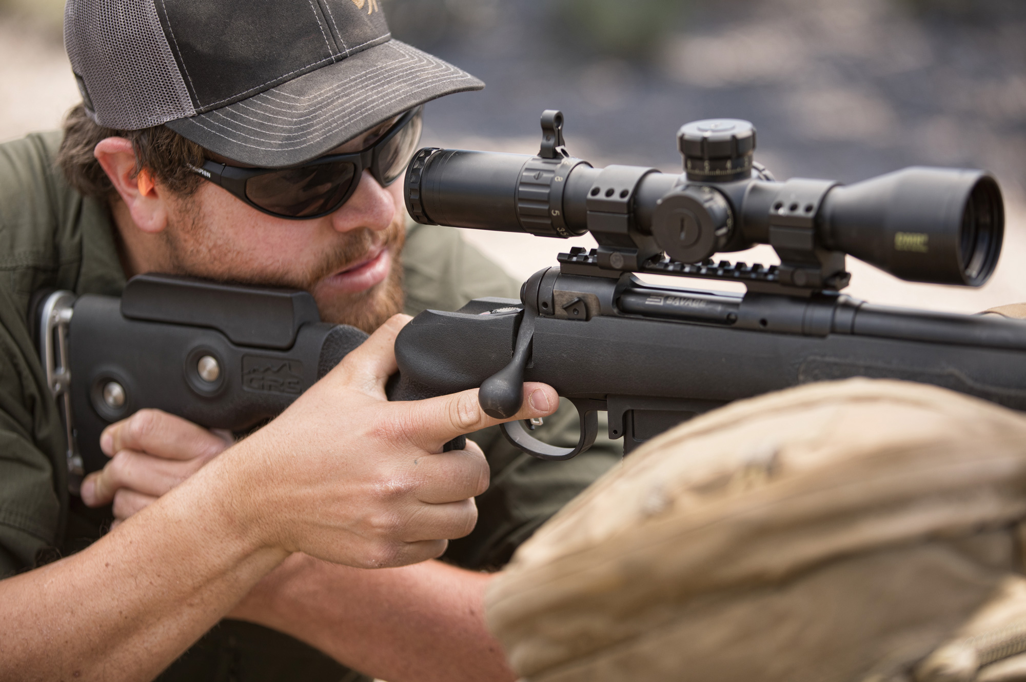 man looking through the scope of a rifle