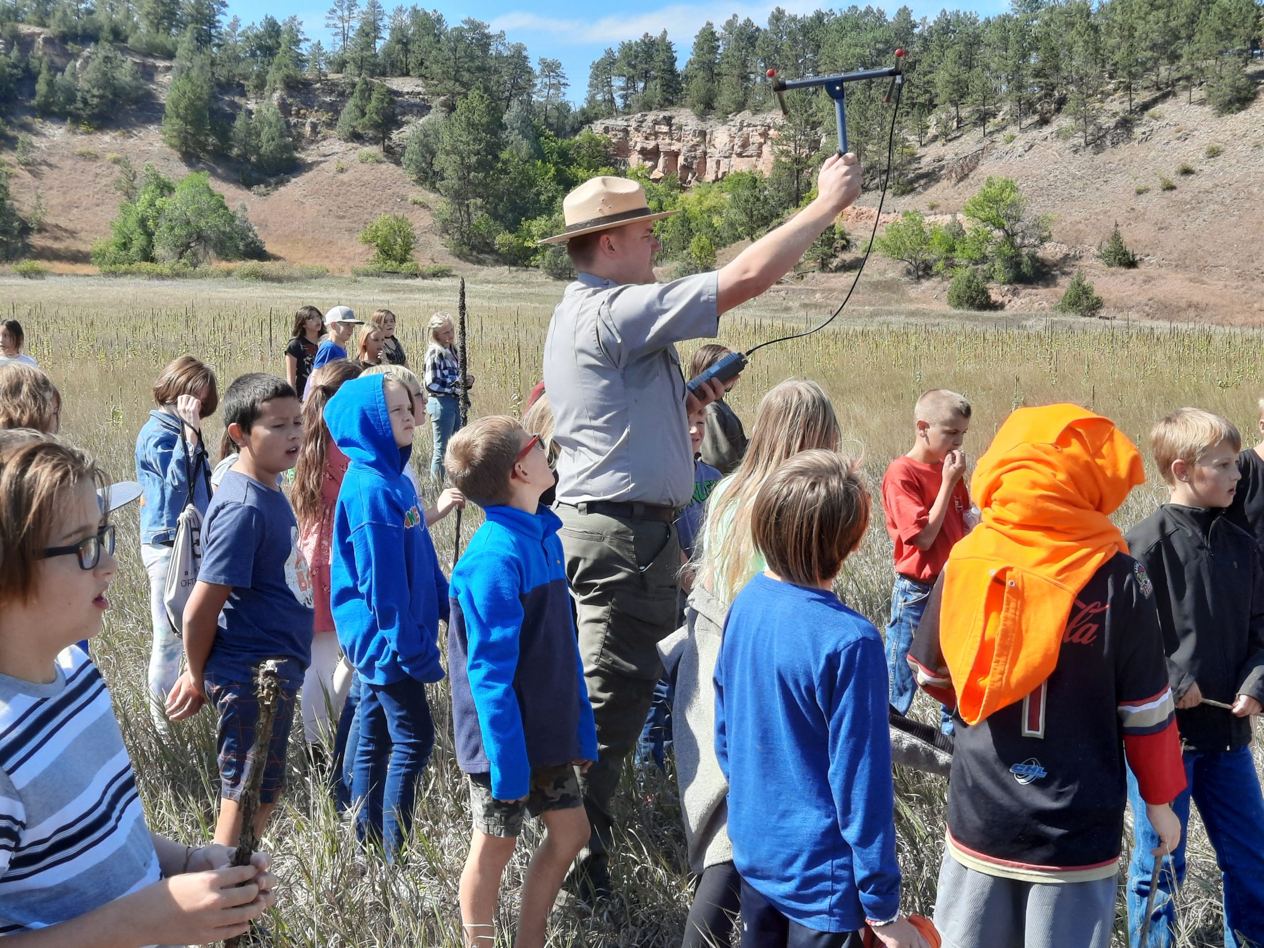 Kids gathered around wildlife researcher