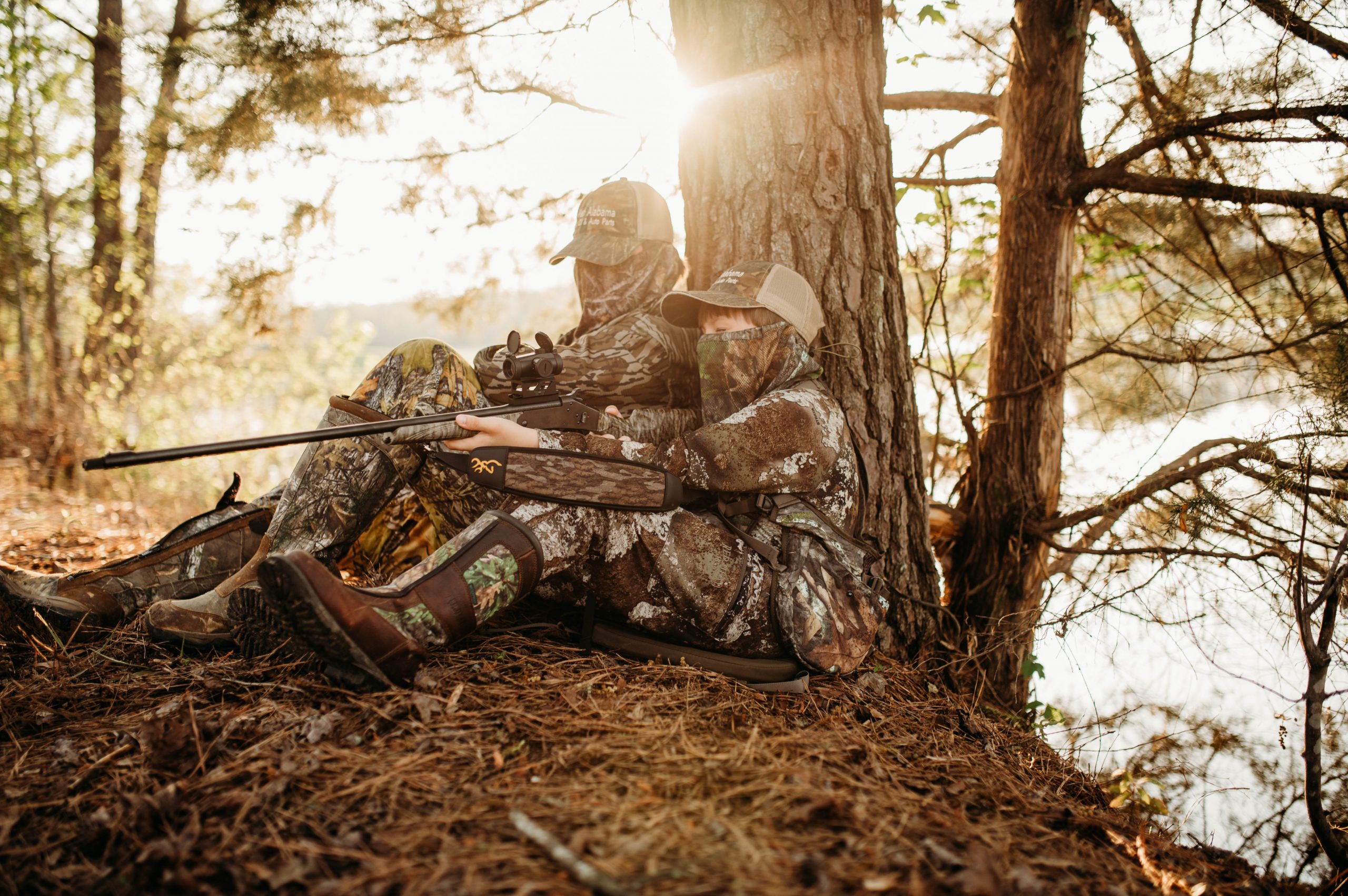 Two hunters sitting in the woods