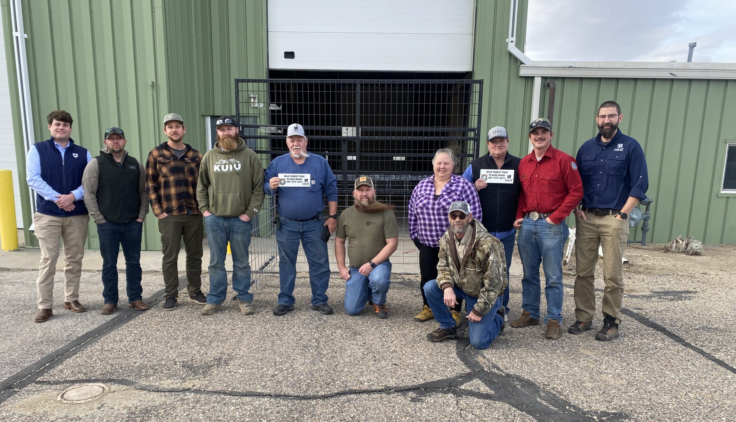 NWTF and Game and Fish stand around the turkey trap